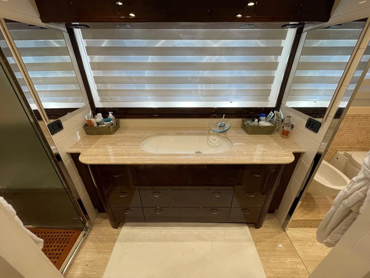 The yacht's bathroom features a luxurious vanity with ample storage and elegant finishes. aboard UNICA Yacht for Sale