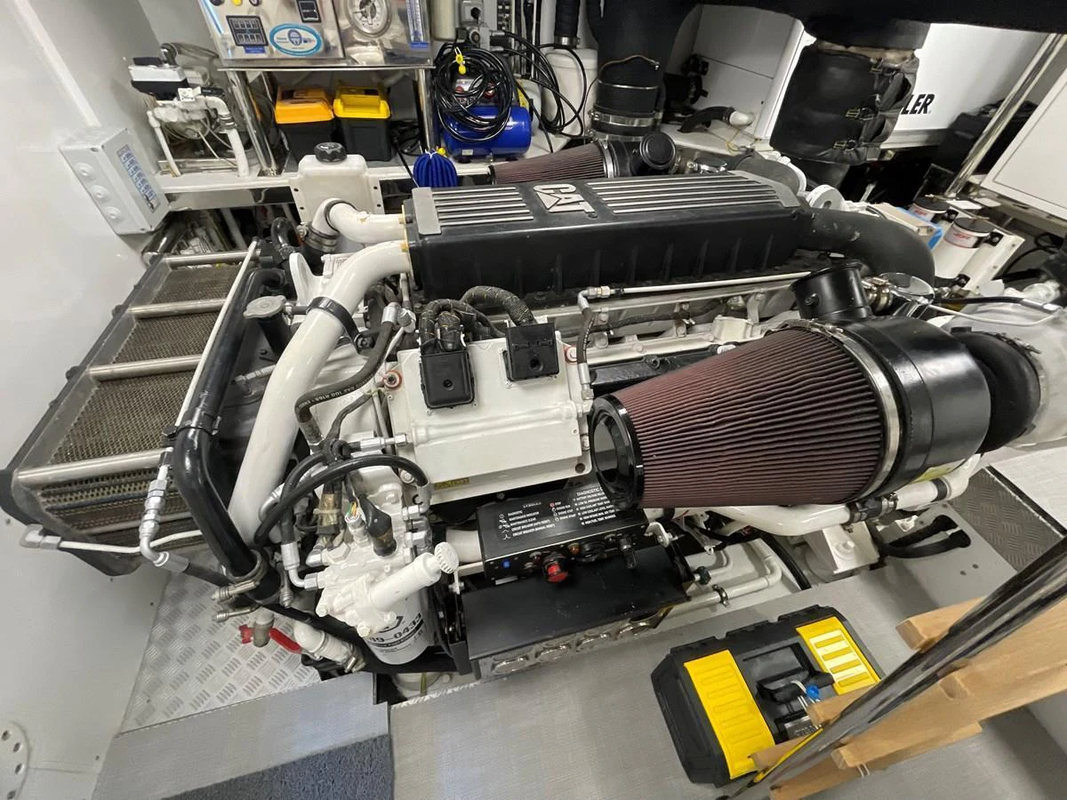The image showcases a meticulously maintained engine room with a powerful engine and various mechanical components. aboard UNICA Yacht for Sale
