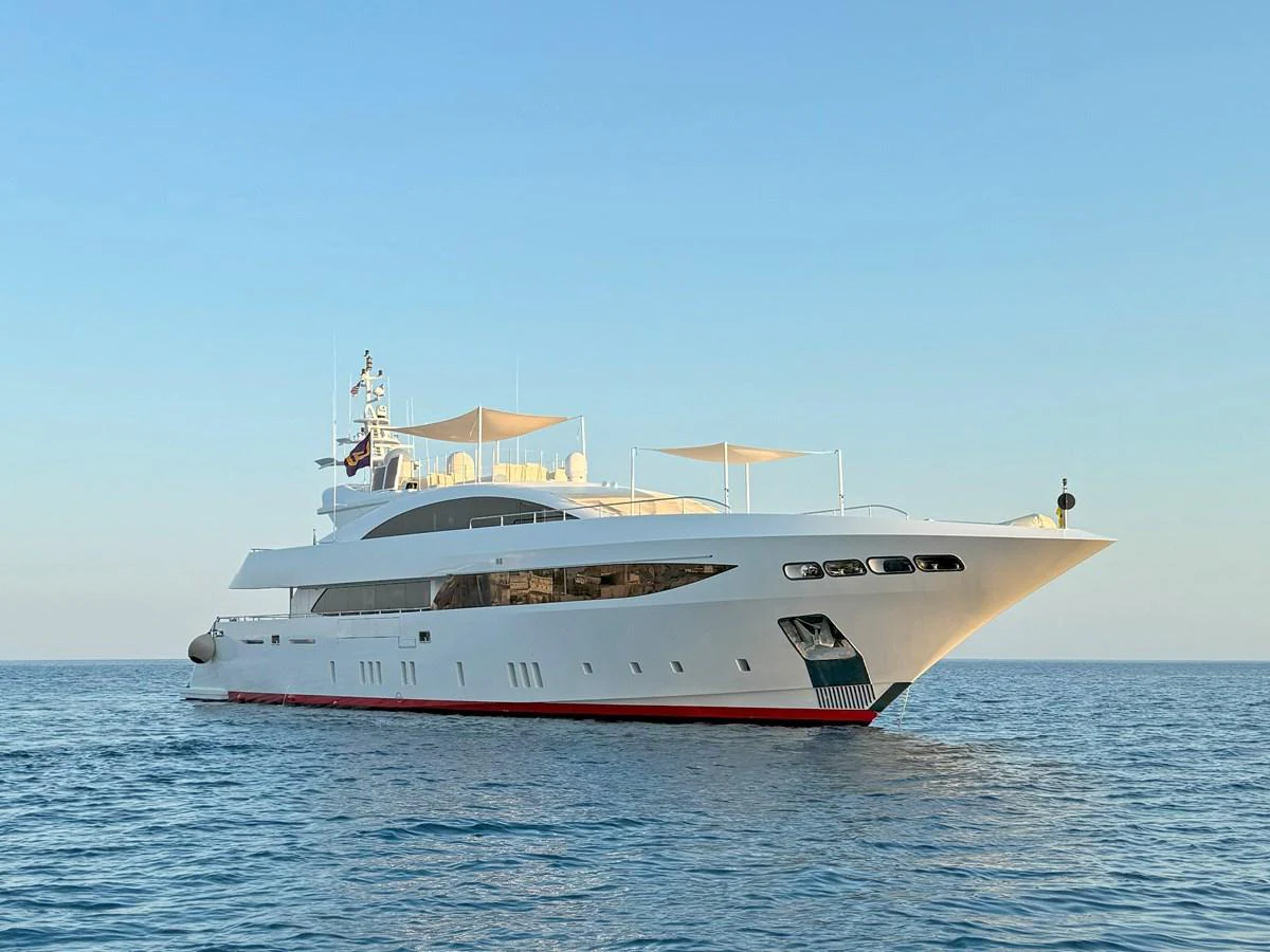 A sleek and modern yacht glides gracefully on the calm sea under a clear sky. aboard BARENTS SEA Yacht for Sale