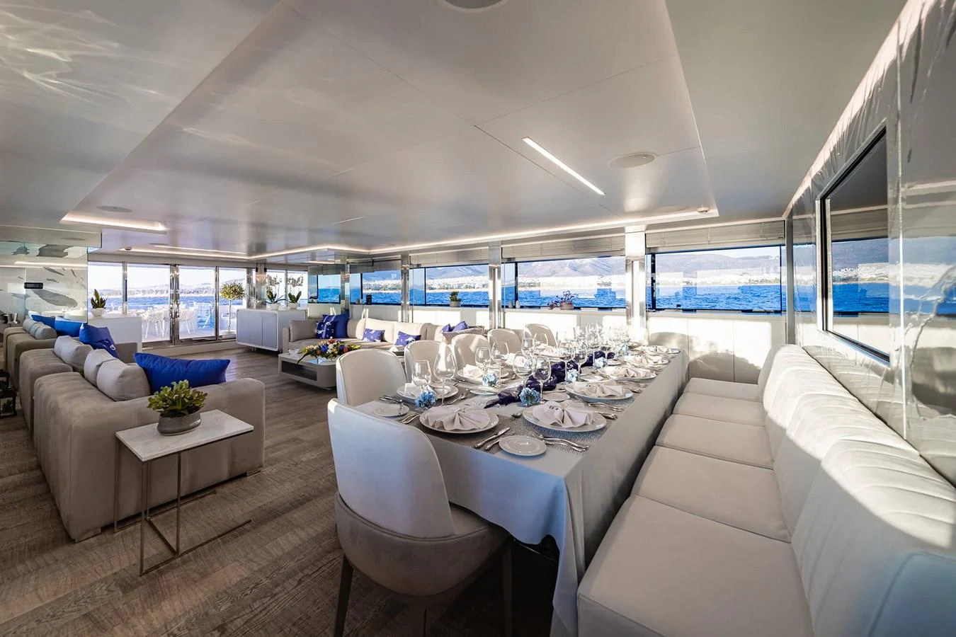 The spacious salon features elegant dining and lounging areas with panoramic ocean views. aboard BARENTS SEA Yacht for Sale