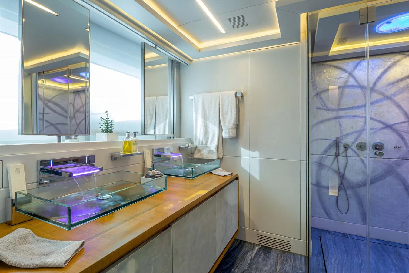 A luxurious yacht bathroom featuring modern fixtures and ambient lighting. aboard BARENTS SEA Yacht for Sale