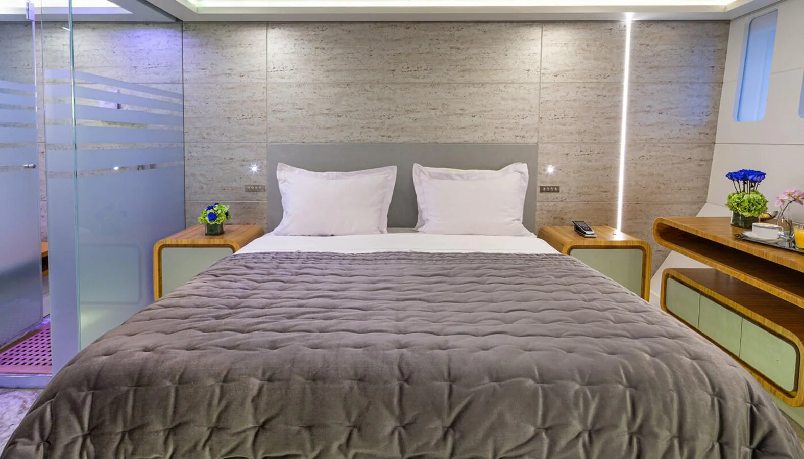 The stateroom features a luxurious bed with plush bedding and modern decor. aboard BARENTS SEA Yacht for Sale