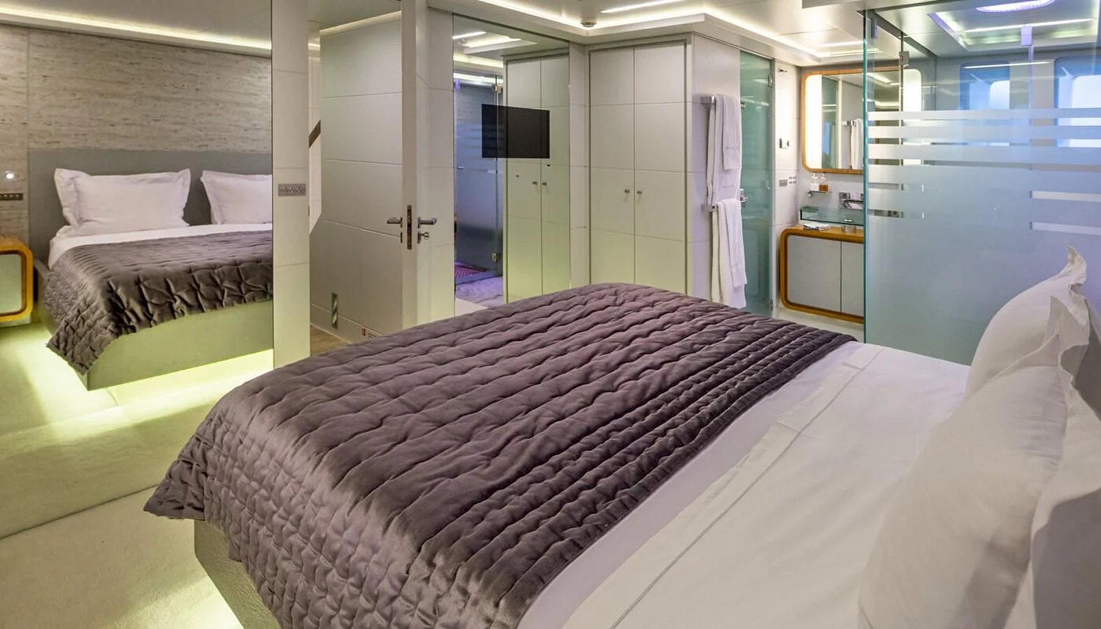 The luxurious stateroom features a plush bed with elegant bedding and modern decor. aboard BARENTS SEA Yacht for Sale