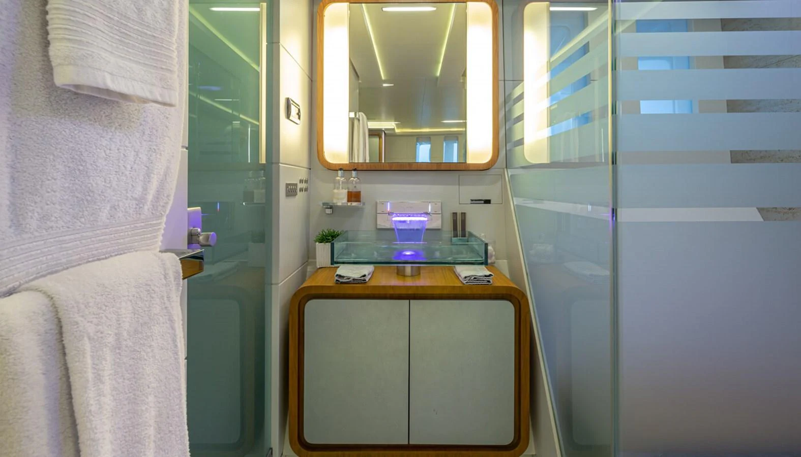 The yacht's bathroom features modern fixtures and a sleek design with frosted glass accents. aboard BARENTS SEA Yacht for Sale