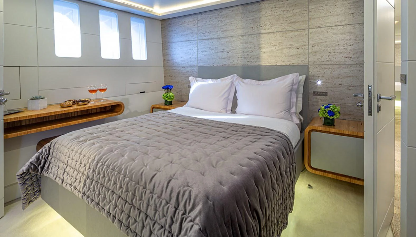 The stateroom features a plush bed with elegant bedding and modern decor. aboard BARENTS SEA Yacht for Sale
