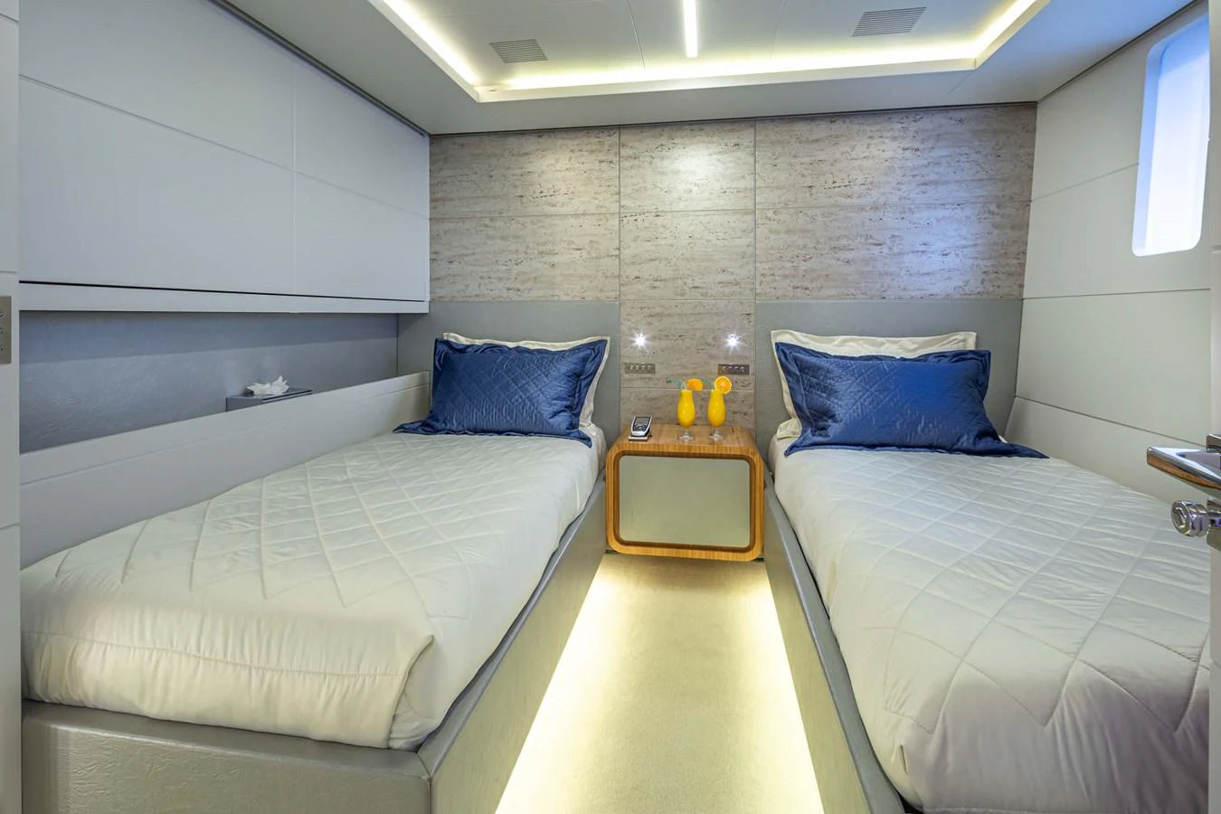 A modern twin stateroom with sleek design and luxurious bedding. aboard BARENTS SEA Yacht for Sale