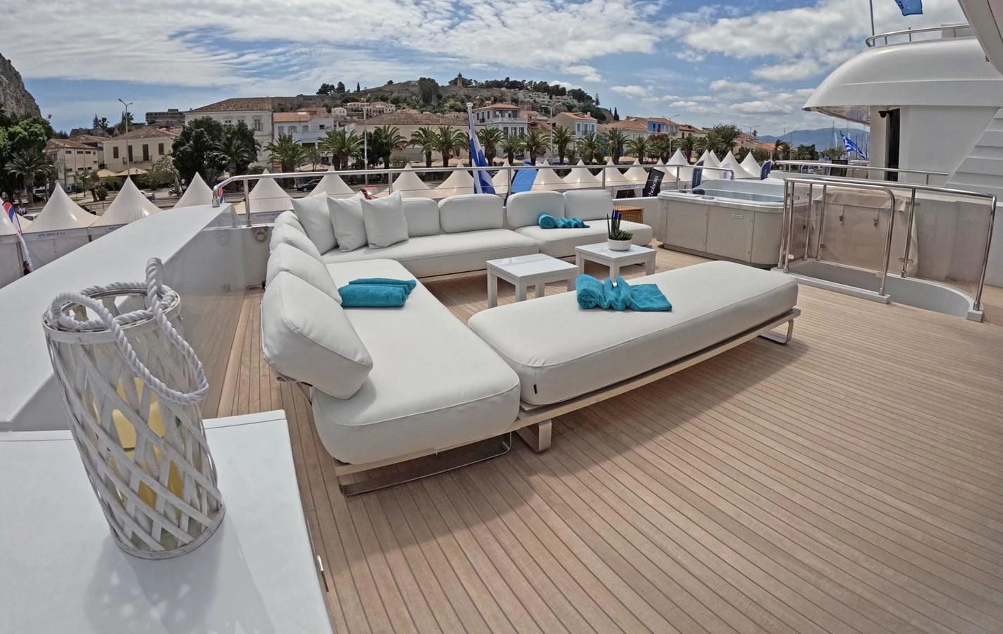The sundeck features luxurious white loungers and a comfortable seating area with turquoise accents, perfect for relaxation. aboard BARENTS SEA Yacht for Sale