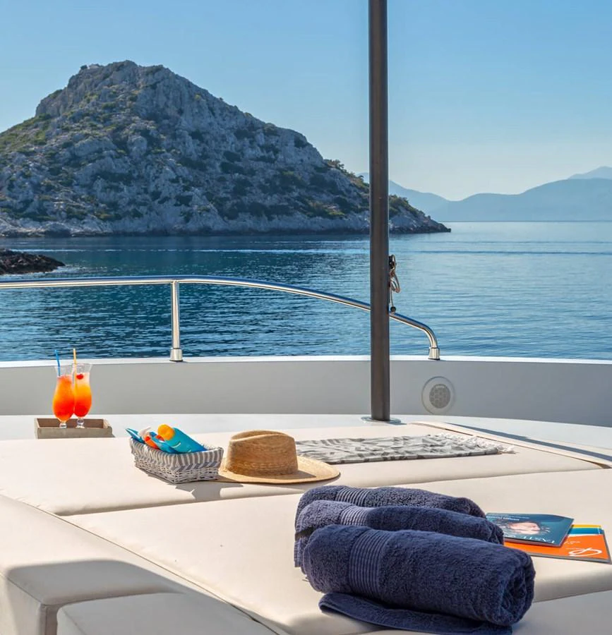 The sundeck offers a serene lounging area with a stunning view of the sea and nearby islands. aboard BARENTS SEA Yacht for Sale