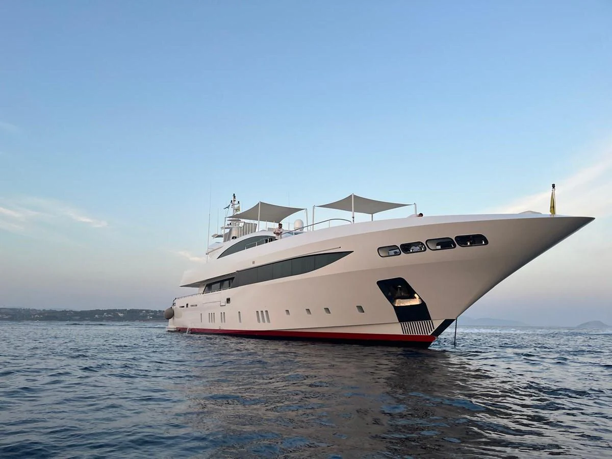 A sleek and modern yacht glides gracefully on calm waters under a clear sky. aboard BARENTS SEA Yacht for Sale