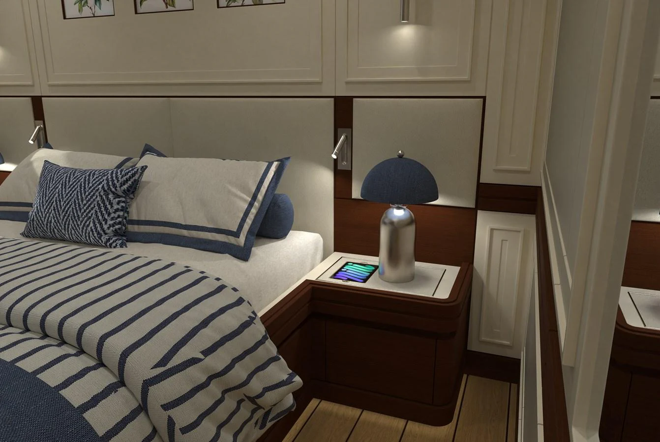 The stateroom features a cozy bed with nautical-themed bedding and a stylish bedside table. aboard MAGNOLIA II Yacht for Sale
