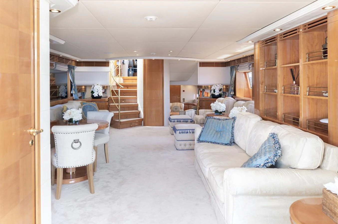 The yacht's salon features plush seating, elegant decor, and ample natural light. aboard M.J. TAKNM Yacht for Sale