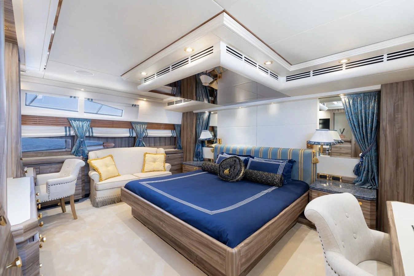 The master stateroom features a luxurious bed with elegant furnishings and ample natural light. aboard M.J. TAKNM Yacht for Sale