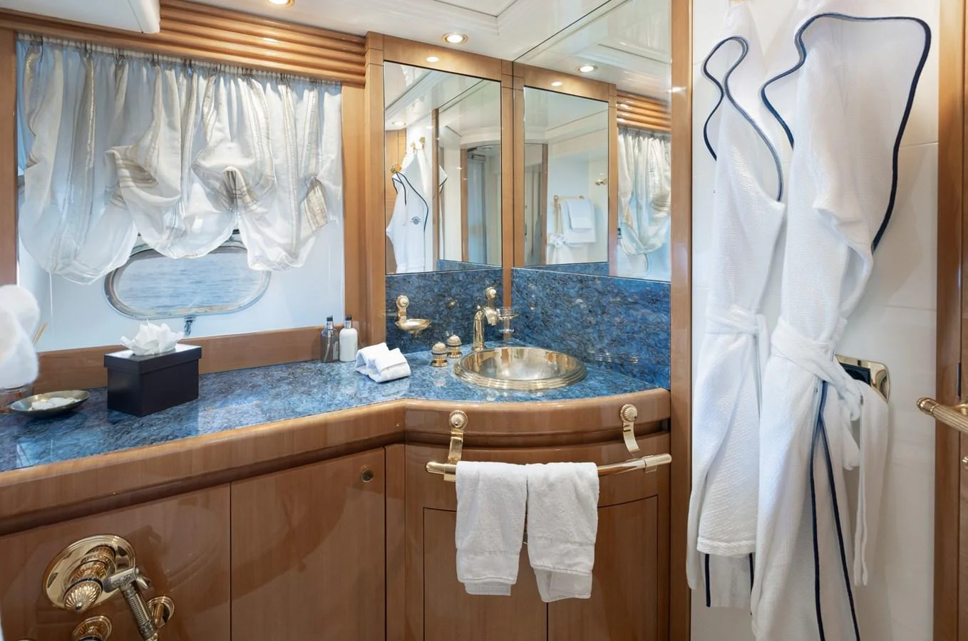 This luxurious yacht bathroom features elegant fixtures and a stylish blue countertop. aboard M.J. TAKNM Yacht for Sale