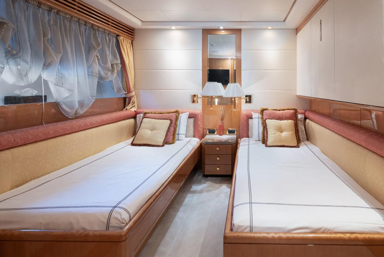 The twin stateroom features two single beds with elegant bedding and tasteful decor. aboard M.J. TAKNM Yacht for Sale