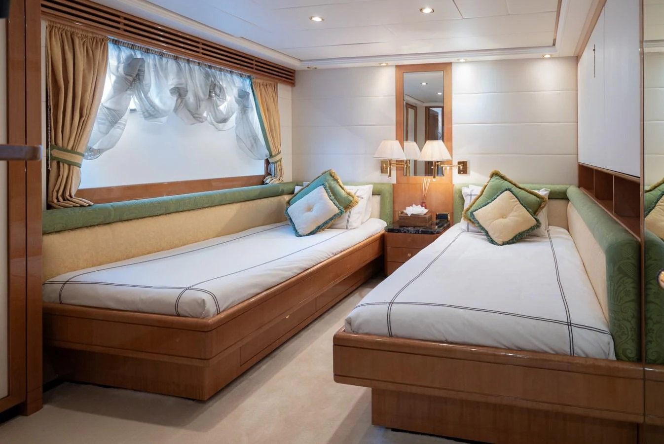 A cozy twin stateroom featuring elegant bedding and warm lighting. aboard M.J. TAKNM Yacht for Sale