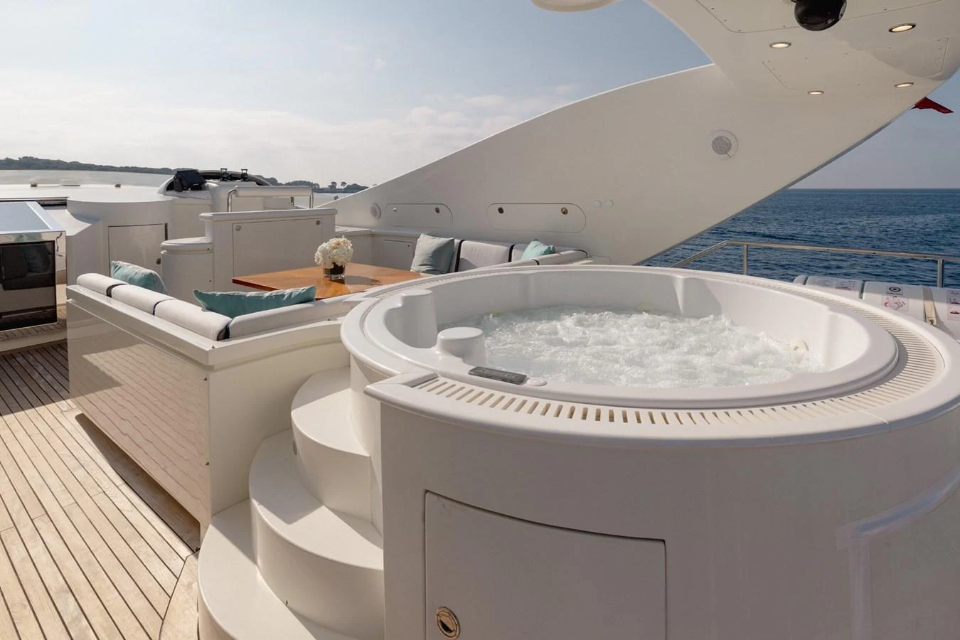 The sundeck features a luxurious jacuzzi with comfortable seating and stunning ocean views. aboard M.J. TAKNM Yacht for Sale