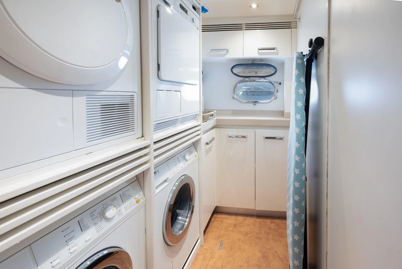 The yacht's laundry room is equipped with modern washing and drying machines for convenience. aboard M.J. TAKNM Yacht for Sale