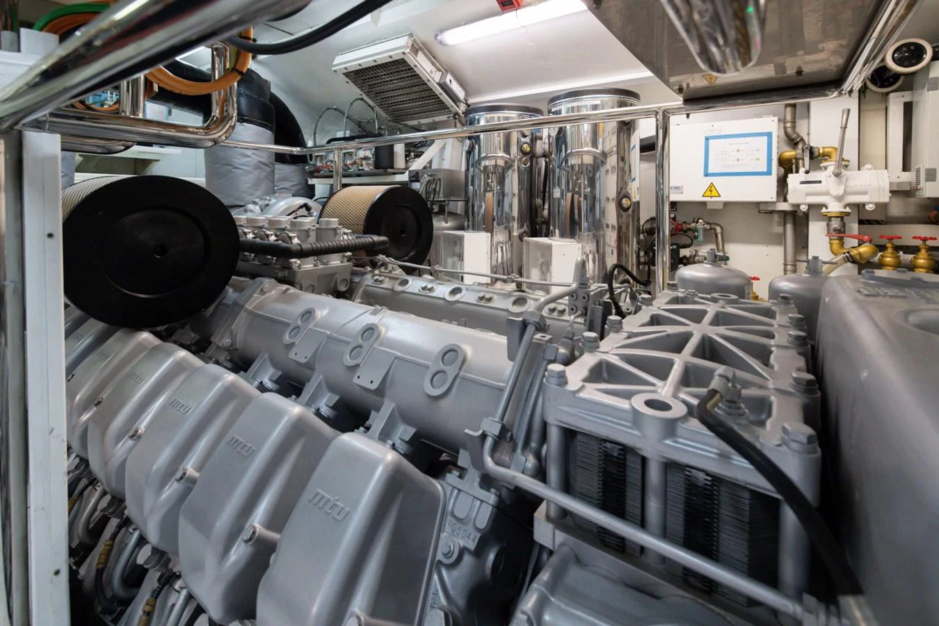 The image showcases the yacht's meticulously maintained engine room with advanced machinery. aboard M.J. TAKNM Yacht for Sale