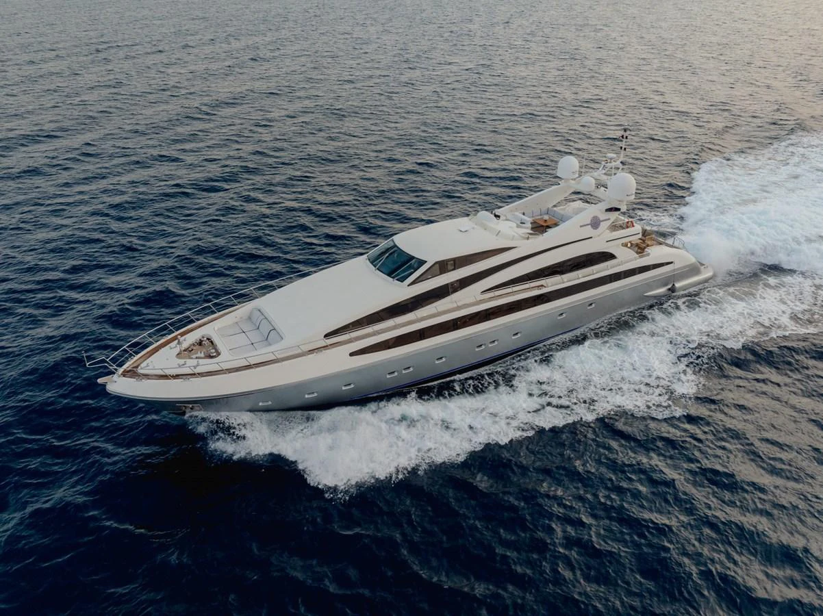 A sleek and modern yacht glides effortlessly through the open sea. aboard M.J. TAKNM Yacht for Sale