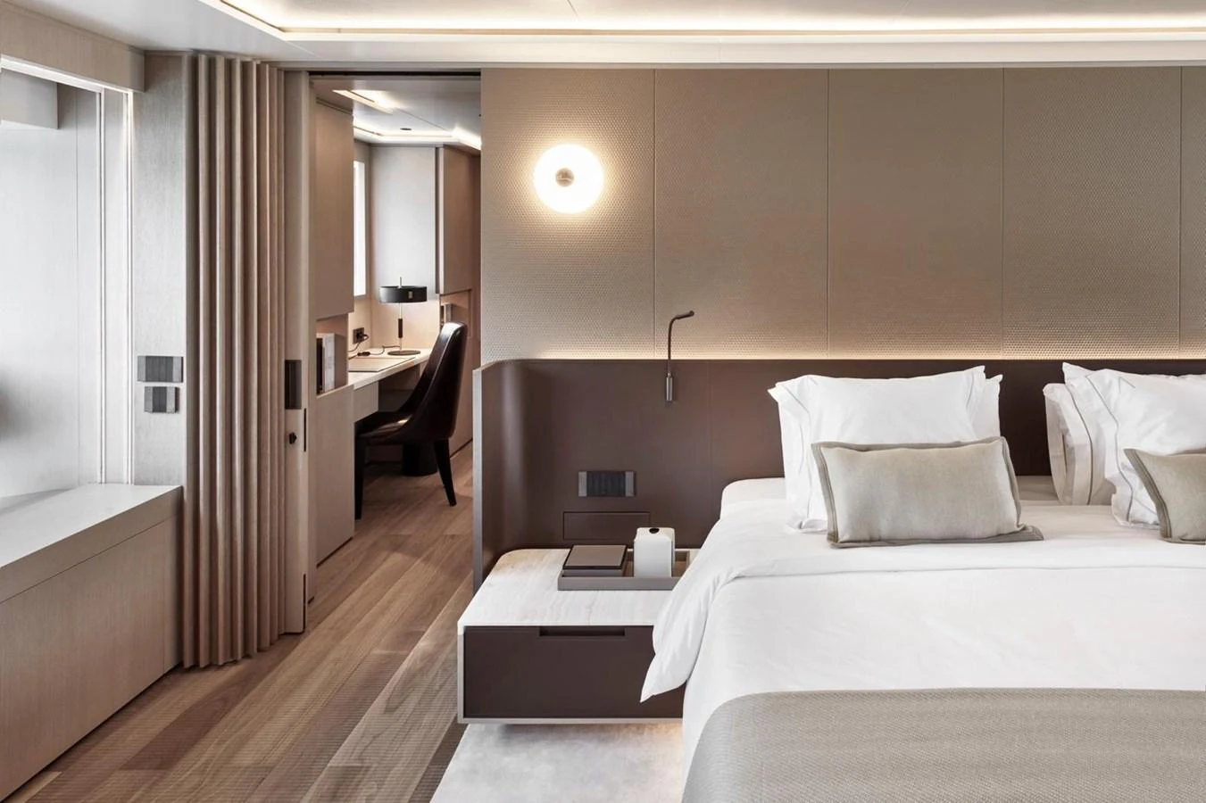 The master stateroom features a luxurious bed with elegant decor and a modern workspace. aboard ATTITUDE Yacht for Sale