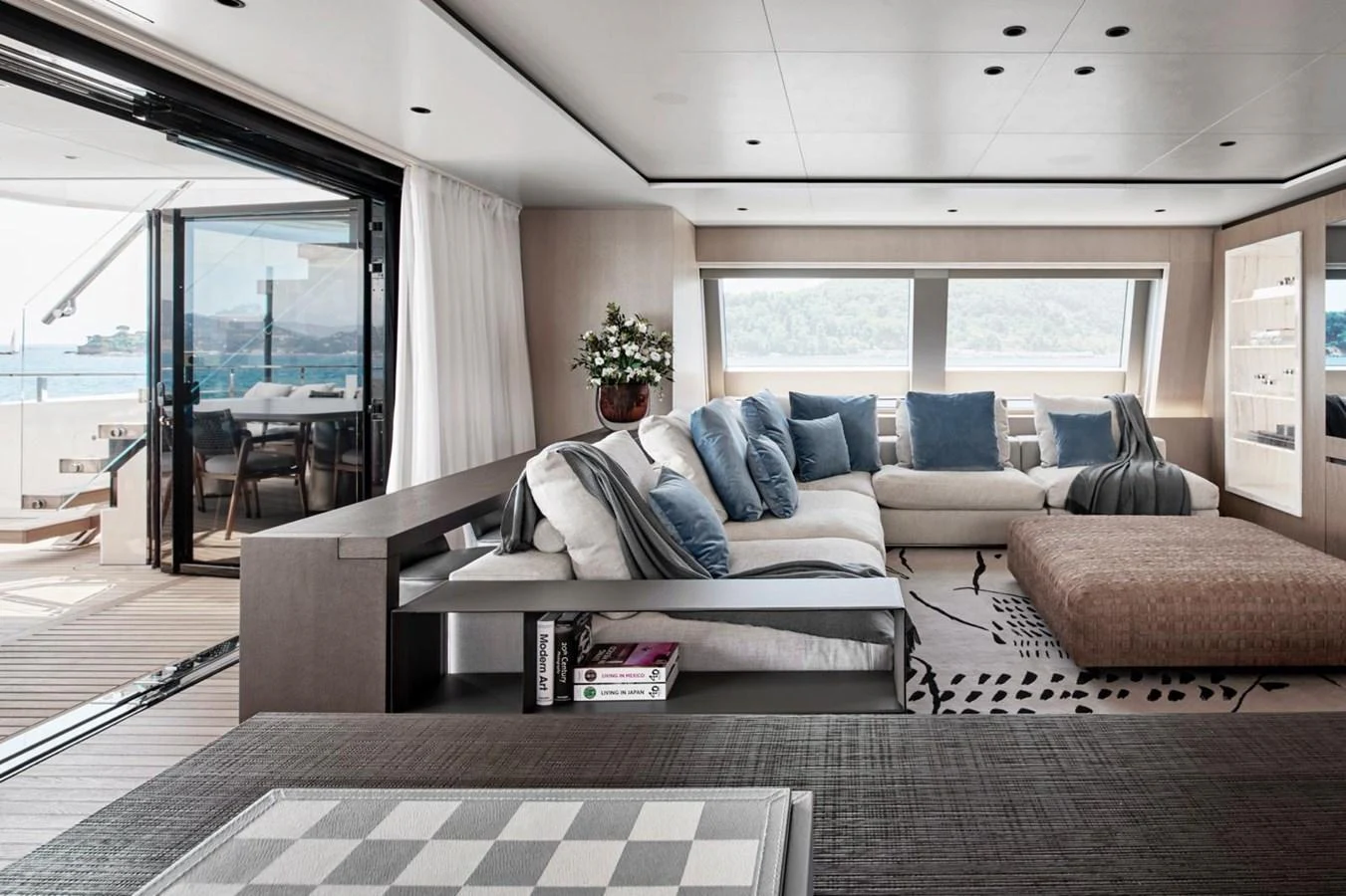 The yacht's salon features a spacious and elegantly designed seating area with large windows offering stunning views. aboard ATTITUDE Yacht for Sale