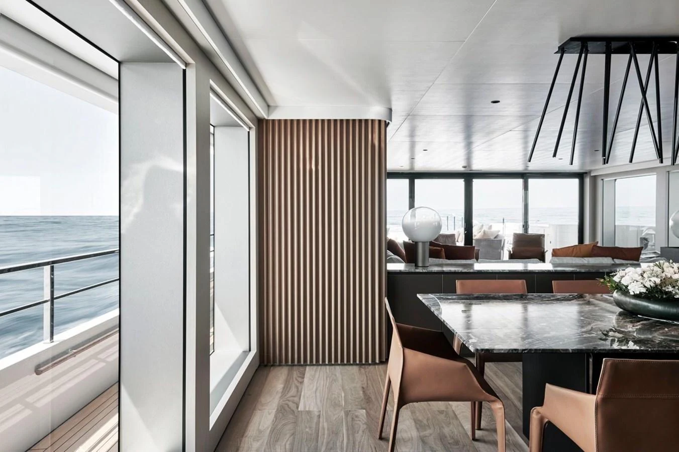 The yacht's salon features modern furnishings with a blend of natural light and elegant decor. aboard ATTITUDE Yacht for Sale