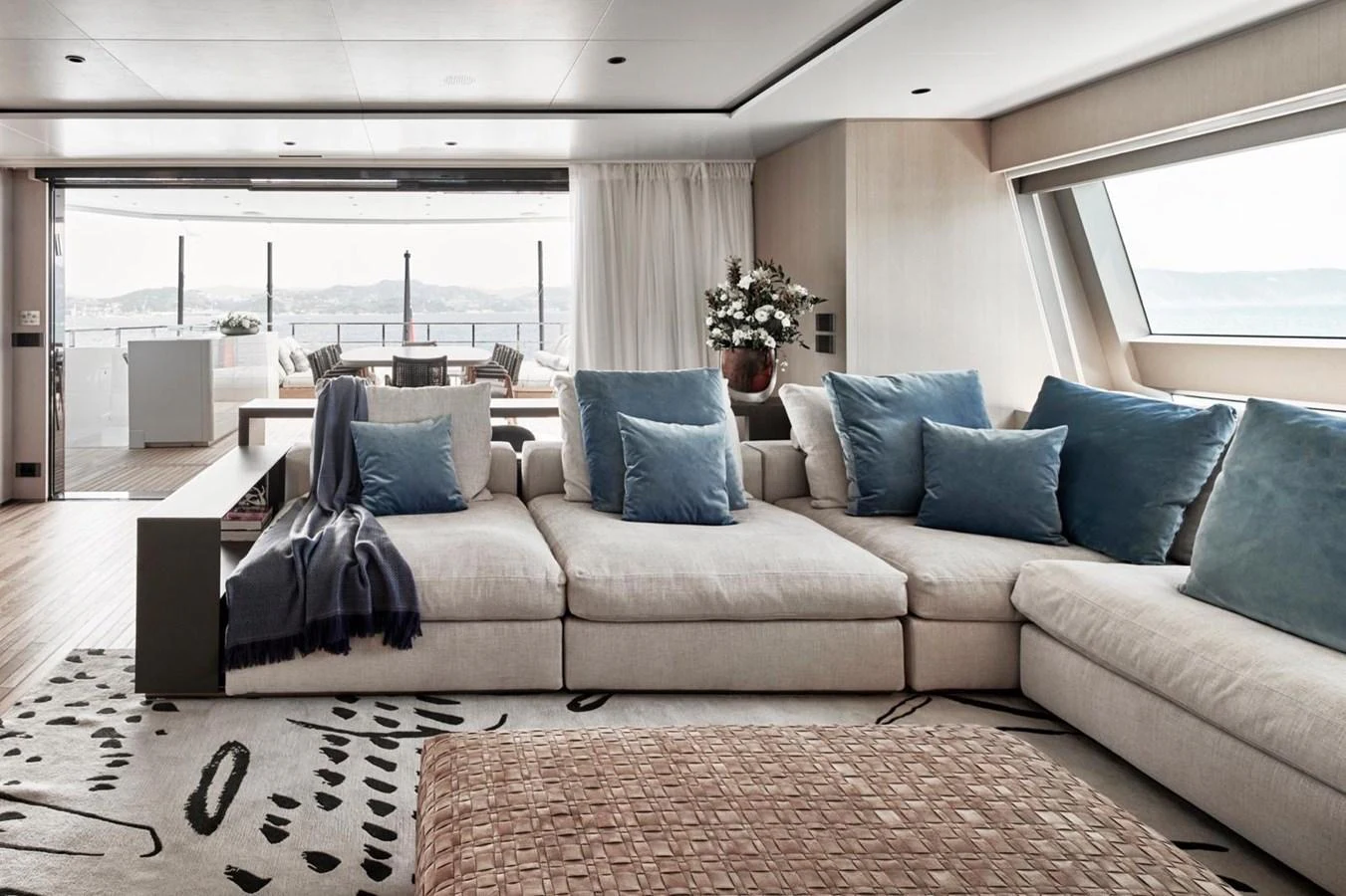 The salon features a spacious and elegant seating area with large windows offering stunning views. aboard ATTITUDE Yacht for Sale