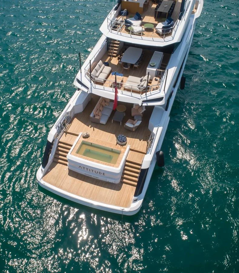 The yacht's aft deck features a luxurious pool and ample seating areas, perfect for relaxation and entertainment. aboard ATTITUDE Yacht for Sale