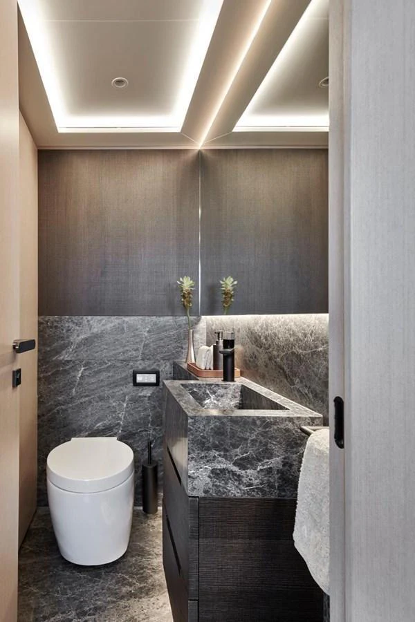 A luxurious yacht bathroom featuring modern fixtures and elegant stone surfaces. aboard ATTITUDE Yacht for Sale