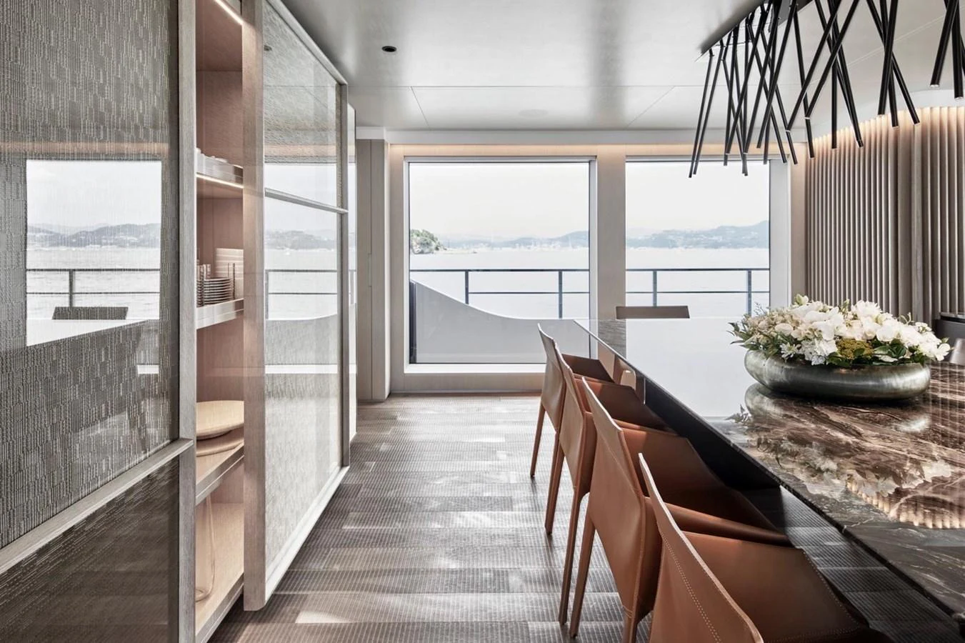 The yacht's dining area features a sleek, modern design with large windows offering stunning sea views. aboard ATTITUDE Yacht for Sale