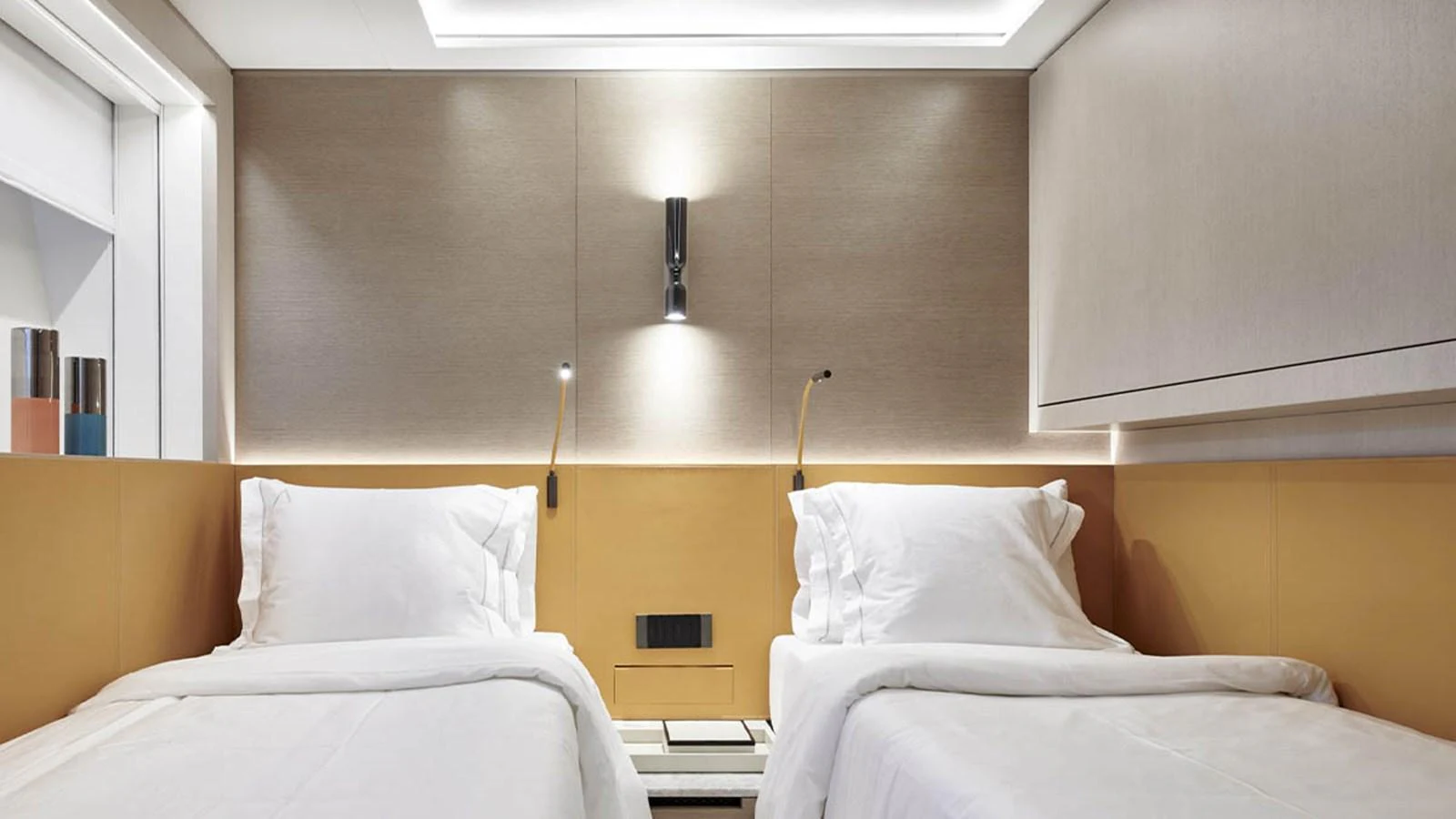The twin stateroom offers a serene and comfortable sleeping area with modern lighting and elegant design. aboard ATTITUDE Yacht for Sale