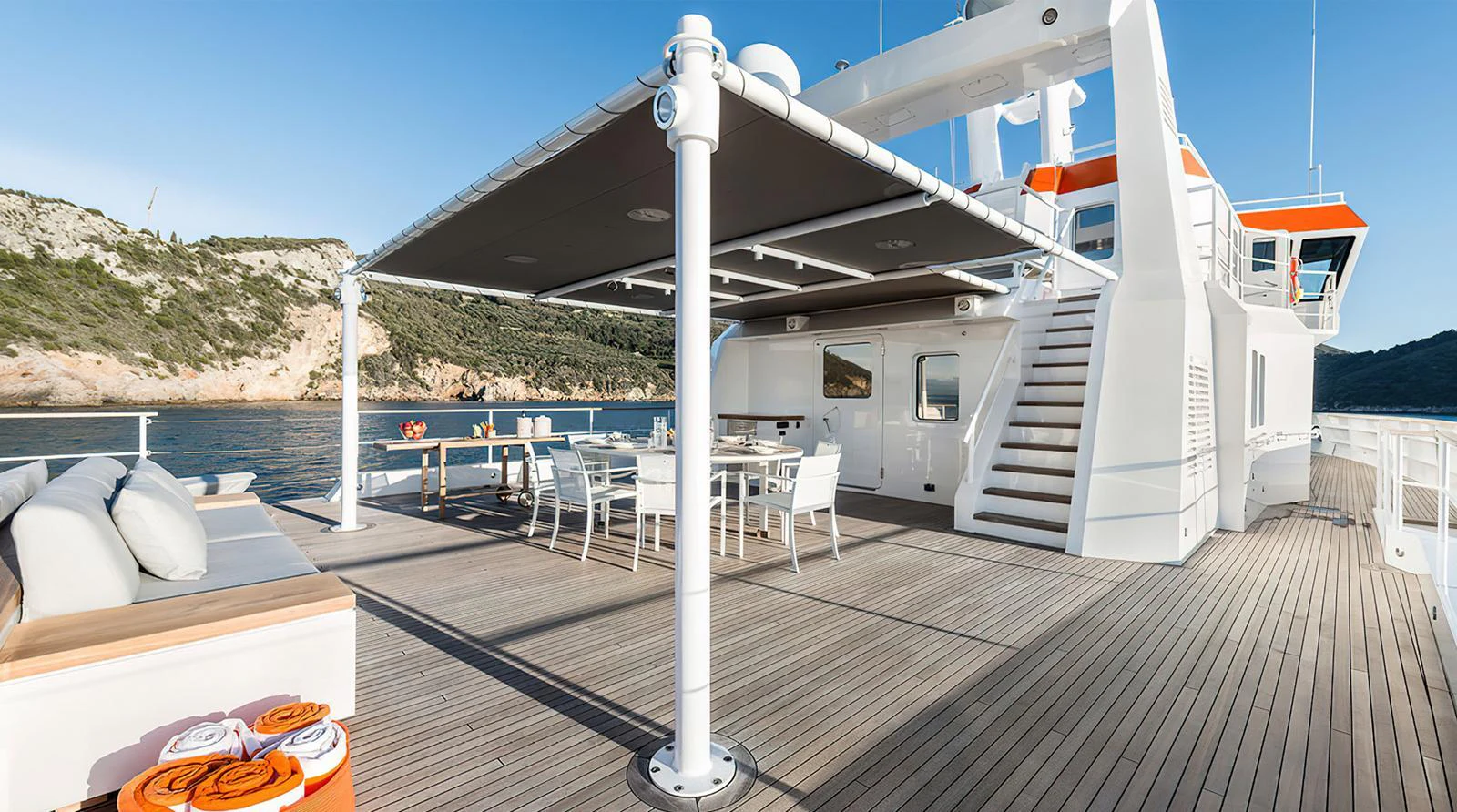 The spacious aft deck offers a luxurious outdoor dining and lounging area with stunning views. aboard EXPLORER 130 Yacht for Sale