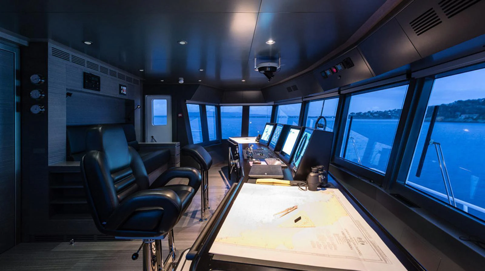 The helm station offers a commanding view with state-of-the-art navigation equipment and luxurious seating. aboard EXPLORER 130 Yacht for Sale