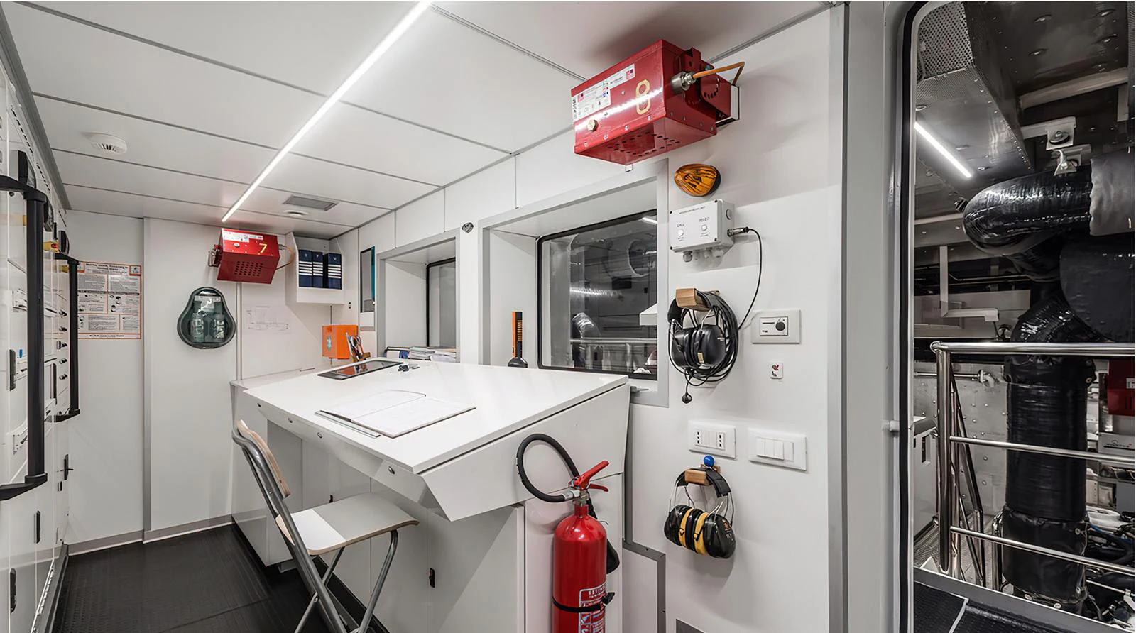 The crew area features a well-organized workspace with essential safety equipment and tools. aboard EXPLORER 130 Yacht for Sale