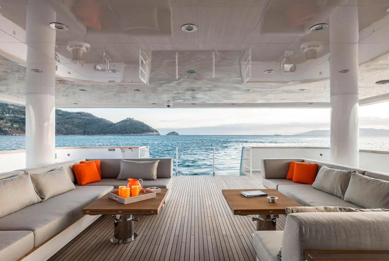 The aft deck offers a spacious and inviting area with comfortable seating and stunning ocean views. aboard EXPLORER 130 Yacht for Sale