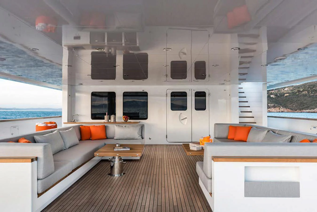 The aft deck features a spacious seating area with modern furnishings and vibrant accents, perfect for relaxation and socializing. aboard EXPLORER 130 Yacht for Sale
