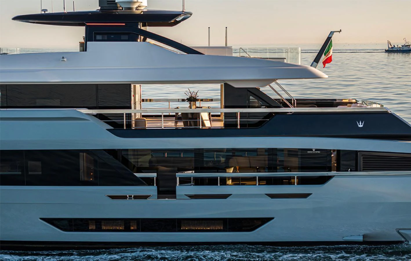 A sleek and modern yacht glides gracefully on calm waters at sunset. aboard DOGE 500 Yacht for Sale