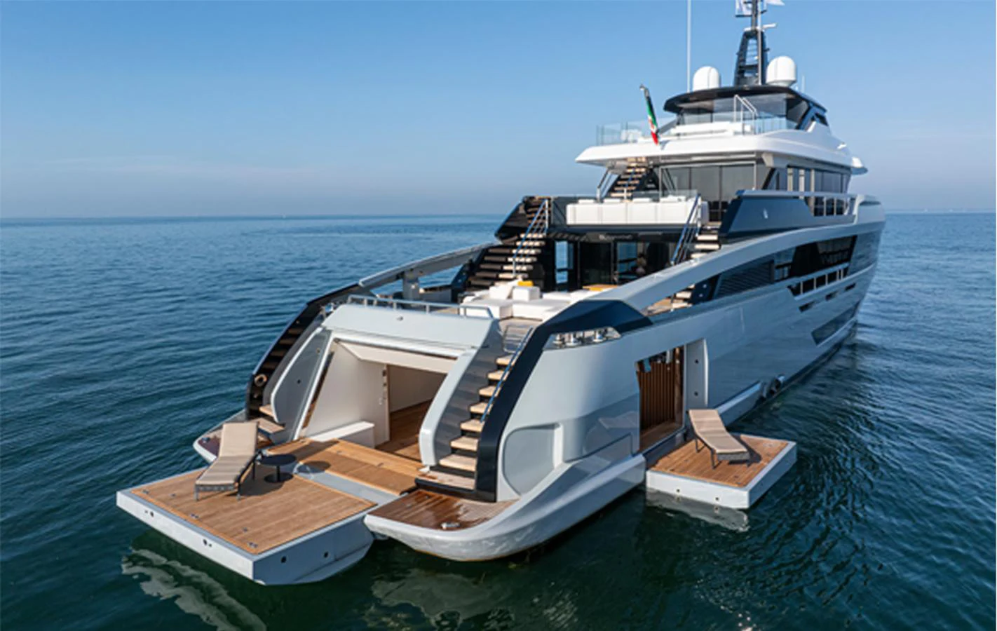 The yacht features an expansive aft deck with luxurious lounging areas and direct access to the water. aboard DOGE 500 Yacht for Sale