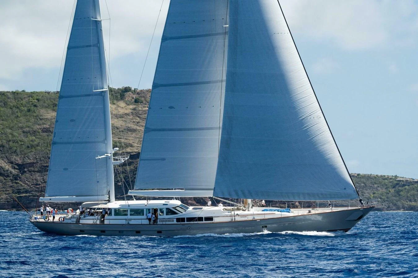 A sleek sailing yacht glides gracefully on the open sea with its sails fully extended. aboard CATALINA Yacht for Sale