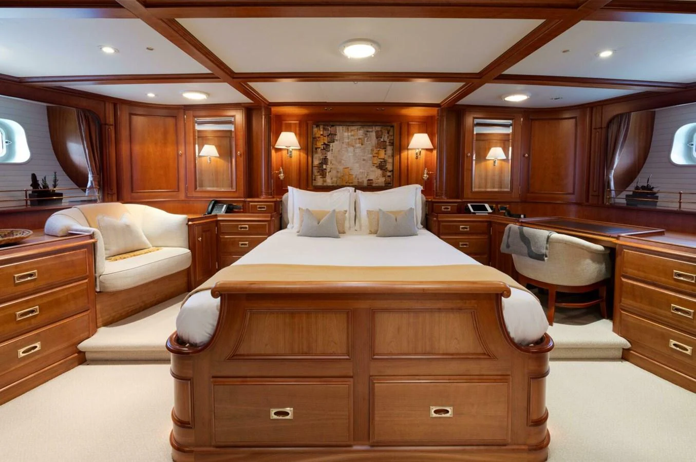 The master stateroom features elegant wood paneling and luxurious bedding, creating a warm and inviting atmosphere. aboard CATALINA Yacht for Sale