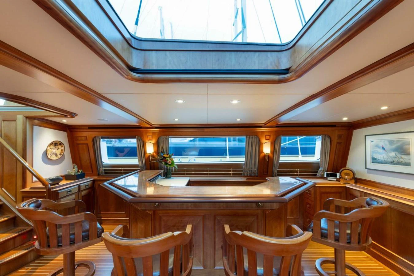 The yacht's saloon features a beautifully crafted wooden bar area with ample natural light from the skylight above. aboard CATALINA Yacht for Sale
