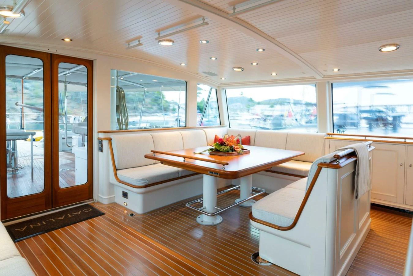 The yacht's dining area features a spacious and elegant setup with ample seating and a beautifully set table. aboard CATALINA Yacht for Sale