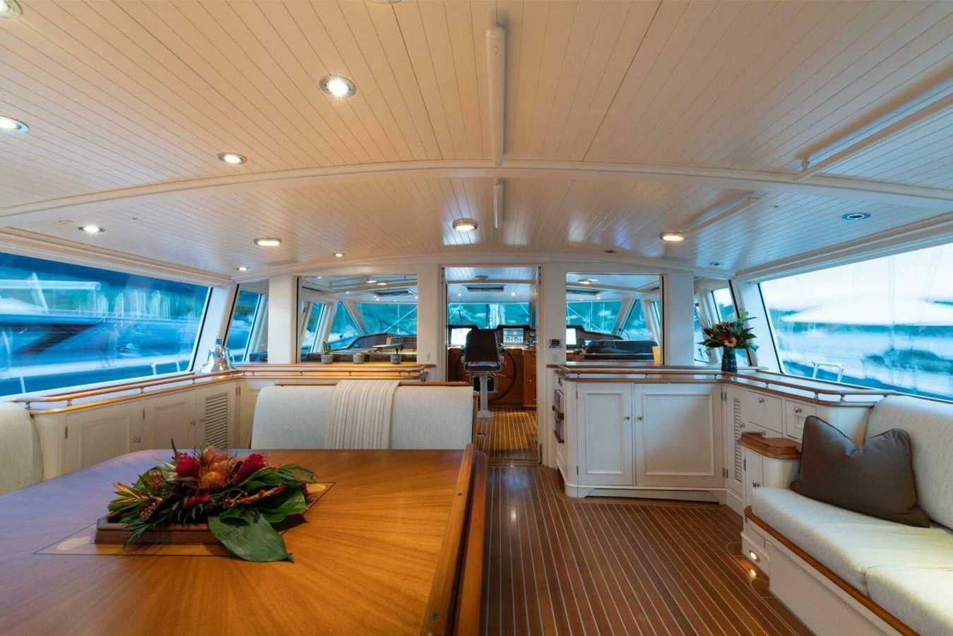 The yacht's salon features elegant wood finishes and ample natural light, creating a warm and inviting atmosphere. aboard CATALINA Yacht for Sale