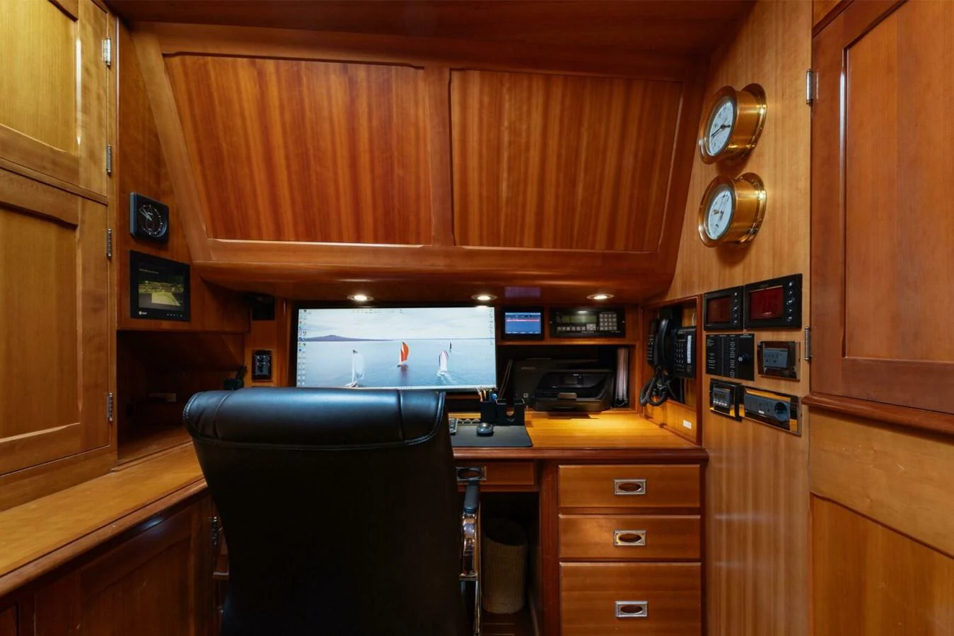 The yacht's office features a well-appointed workspace with rich wood finishes and modern equipment. aboard CATALINA Yacht for Sale