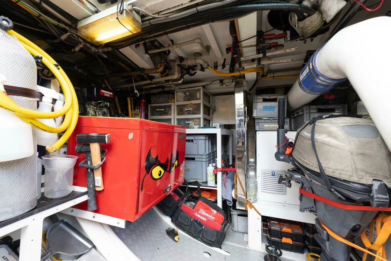 The image showcases a well-organized engine room with various tools and equipment neatly arranged. aboard CATALINA Yacht for Sale