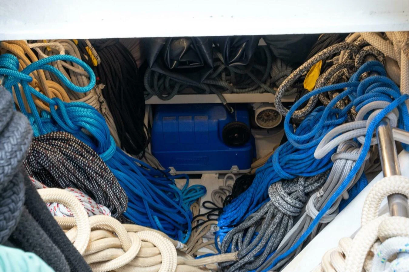 A storage area filled with various ropes and lines, showcasing the yacht's preparedness for sailing. aboard CATALINA Yacht for Sale