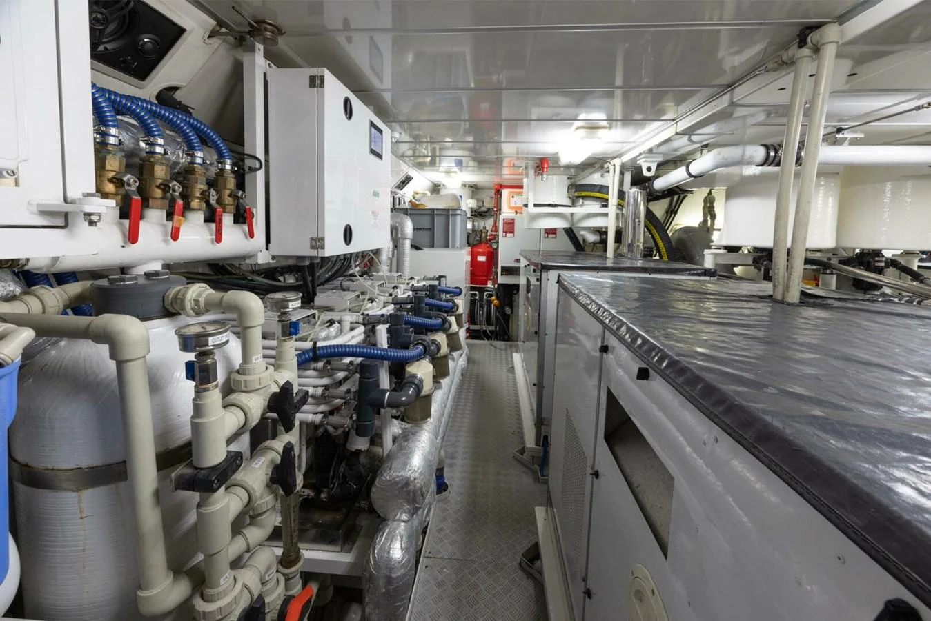 The image showcases the yacht's well-organized engine room with various mechanical and electrical components. aboard CATALINA Yacht for Sale