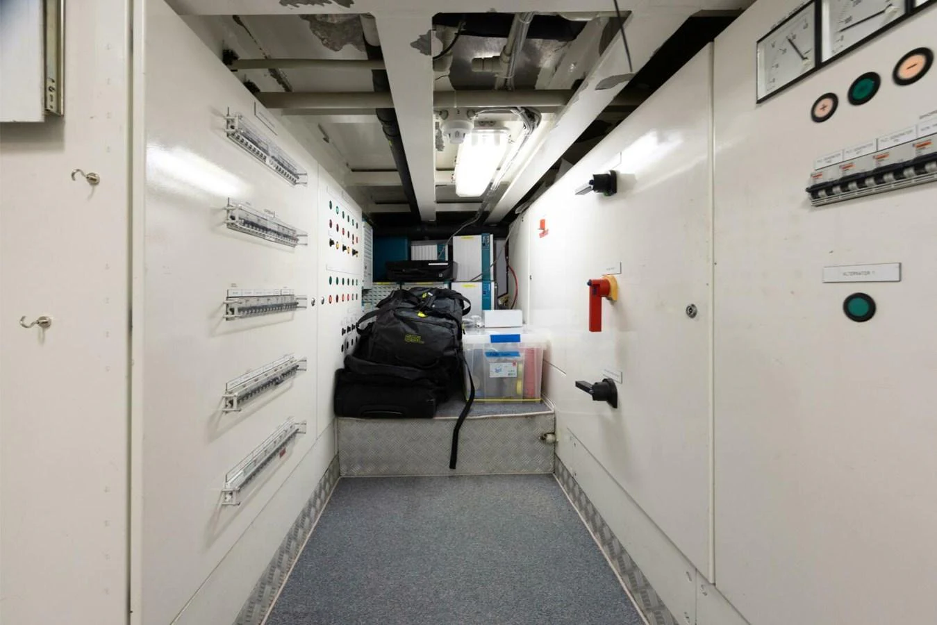 The image showcases the organized and well-maintained engine room of the yacht, highlighting its technical equipment and storage solutions. aboard CATALINA Yacht for Sale