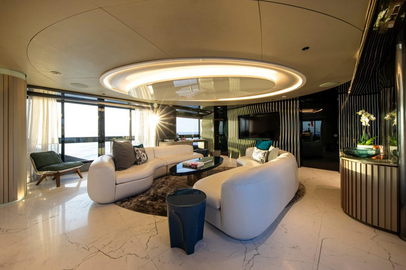The salon features luxurious seating with modern decor and ample natural light. aboard PACIFIC PEARL Yacht for Sale