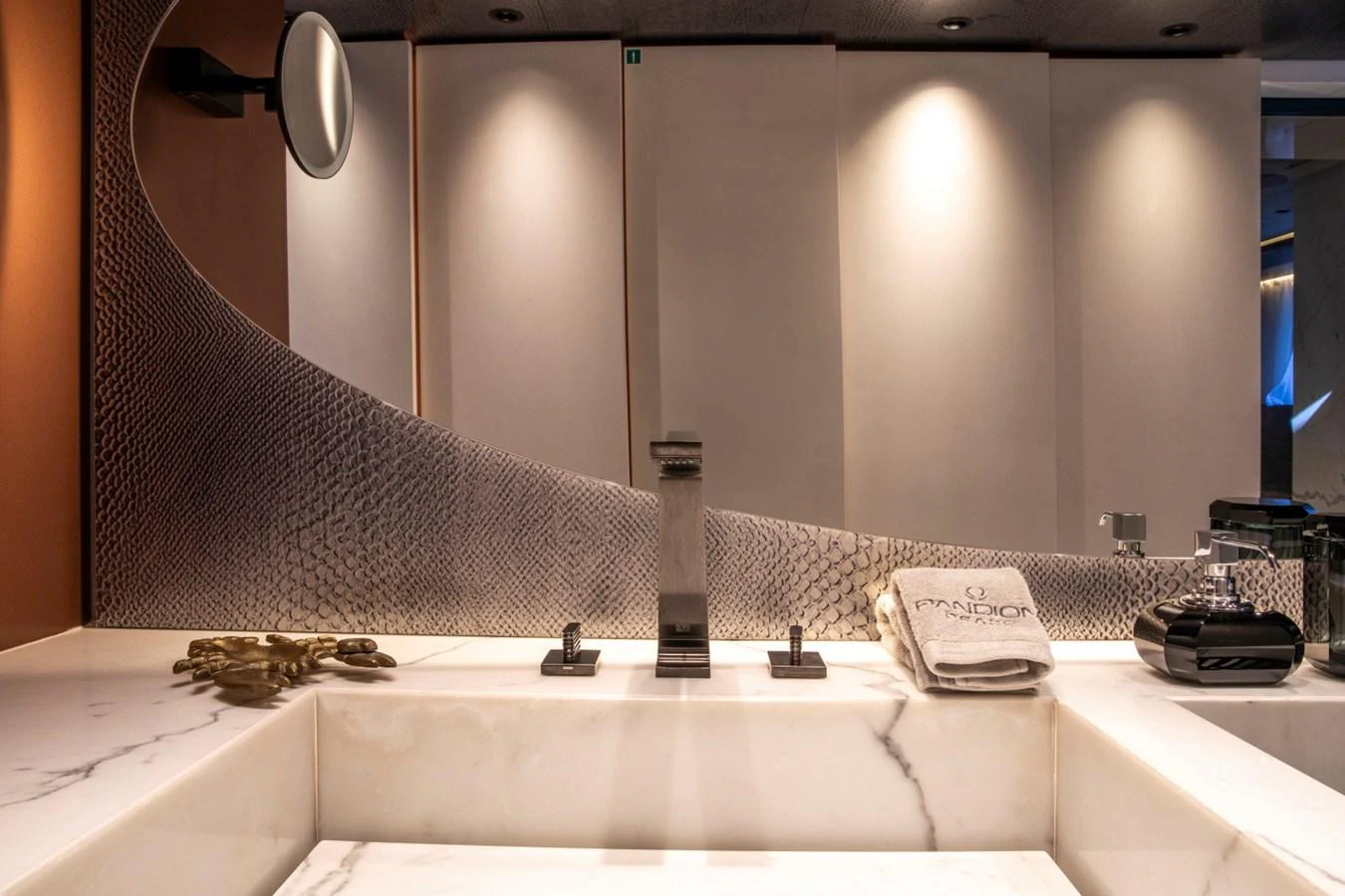 The luxurious bathroom features a sleek marble sink and modern fixtures, exuding elegance and sophistication. aboard PACIFIC PEARL Yacht for Sale